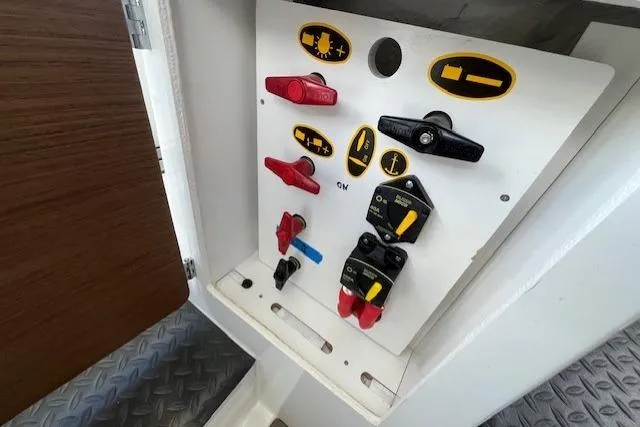 Slide: The Image of Control panel of a 2023 Beneteau Antares 8 boat with labeled switches and indicators. - 18