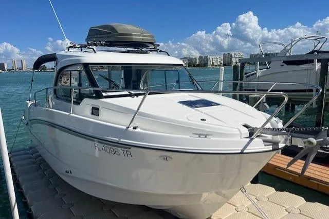 Slide: The Image of 2023 Beneteau Antares 8 boat docked on a sunny day with city skyline. - 3