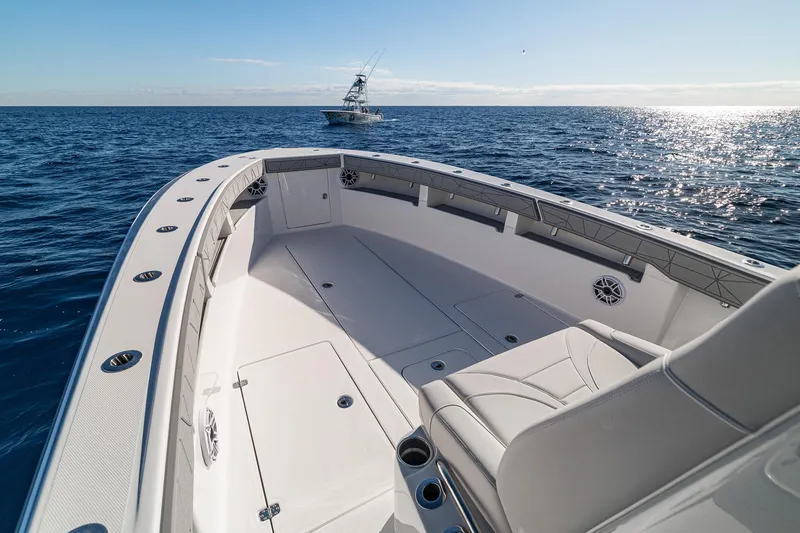 Slide: The Image of 2026 SeaVee 320B boat on open ocean, featuring spacious deck and seating. - 12