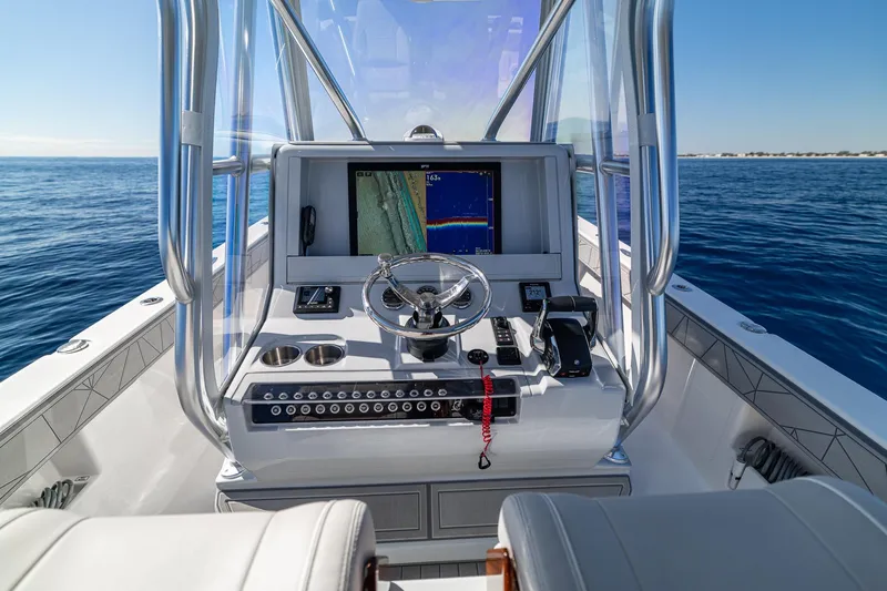 Slide: The Image of 2026 SeaVee 320B boat console with navigation display on open water. - 16