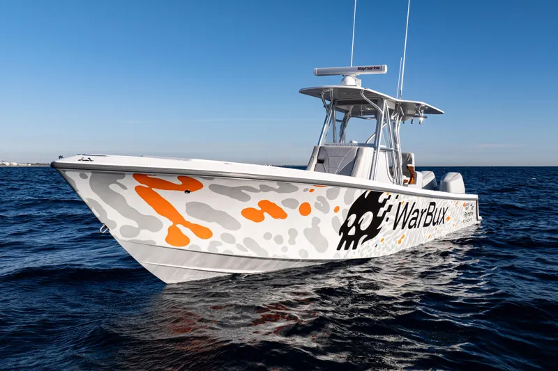 Slide: The Image of Aerial view of 2026 SeaVee 320B boat on deep blue ocean water. - 2