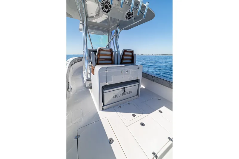 Slide: The Image of 2026 SeaVee 320B boat interior with seating and storage on calm water. - 20