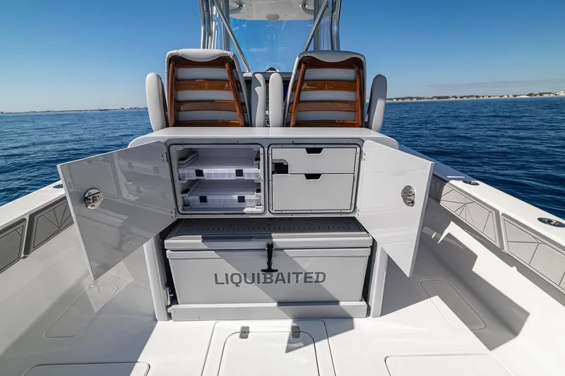 Slide: The Image of 2026 SeaVee 320B boat with open storage compartments and cooler on deck. - 22