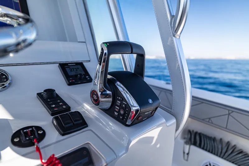 Slide: The Image of Control panel of 2026 SeaVee 320B boat with throttle and navigation instruments. - 23