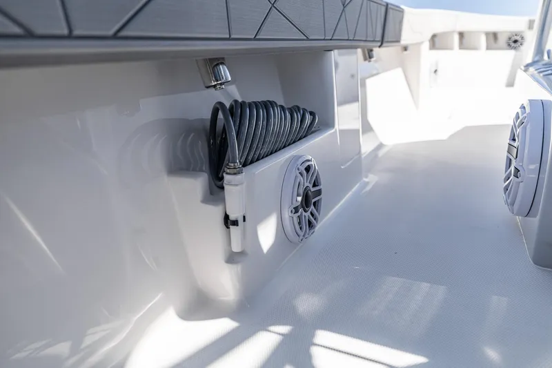 Slide: The Image of 2026 SeaVee 320B boat interior with coiled hose and speaker system. - 27