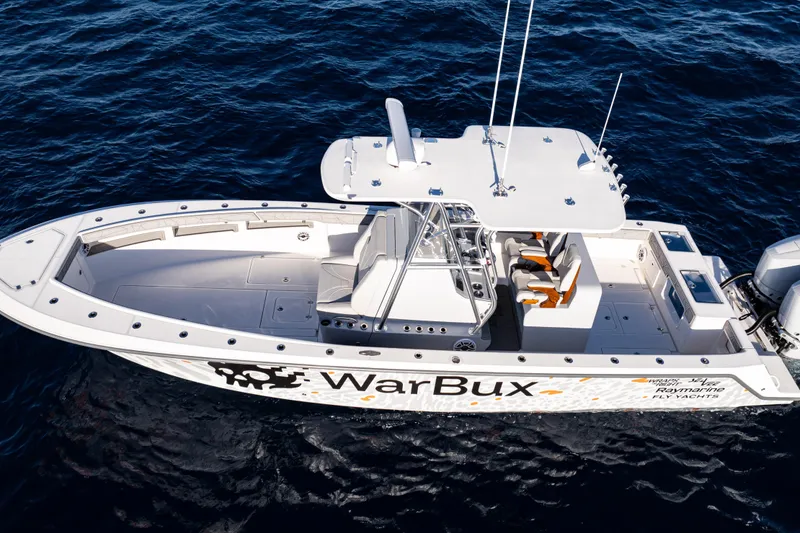 Slide: The Image of 2026 SeaVee 320B boat on water with custom "WarBux" graphics and logos. - 3