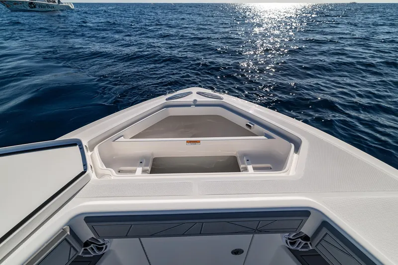 Slide: The Image of 2026 SeaVee 320B boat bow on open ocean, sunlight reflecting on water. - 32