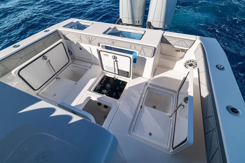 Slide: The Image of 2026 SeaVee 320B boat deck with open storage compartments and ocean backdrop. - 35