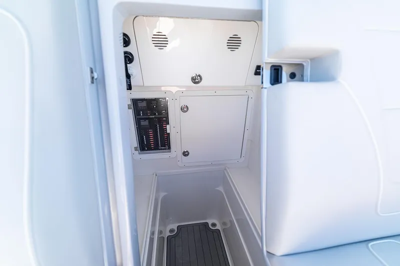Slide: The Image of 2026 SeaVee 320B boat interior with control panel and storage compartment. - 36
