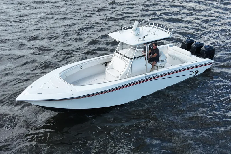 Slide: The Image of 2005 Fountain 34 Tournament Edition boat on water, featuring triple outboard engines. - 13