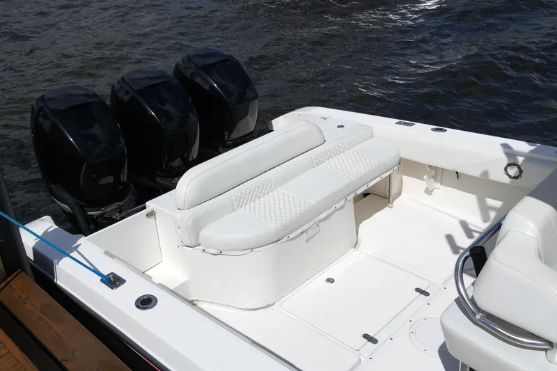 Slide: The Image of 2005 Fountain 34 Tournament Edition boat with triple outboard engines and white seating. - 21
