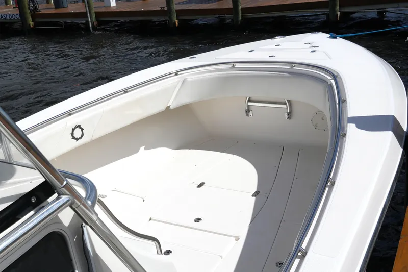 Slide: The Image of 2005 Fountain 34 Tournament Edition boat, spacious deck, docked by the water. - 22