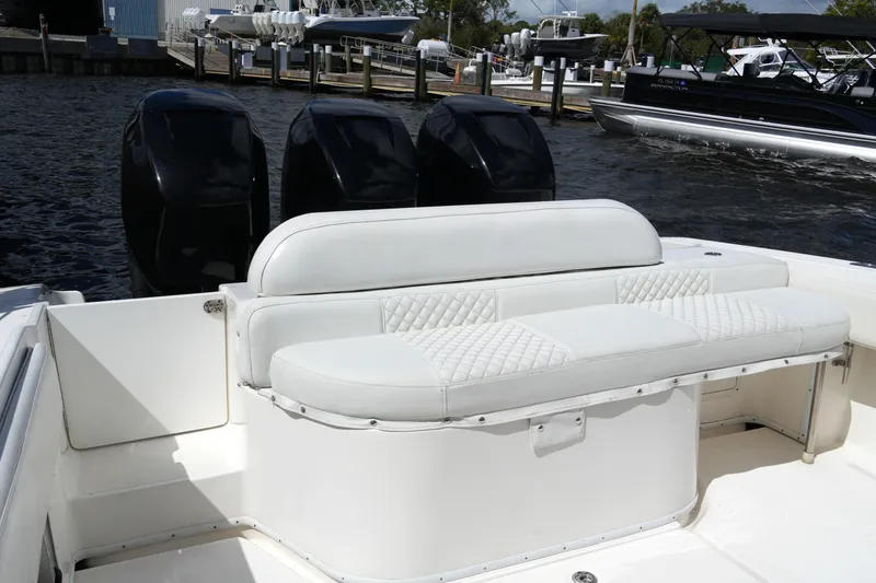 Slide: The Image of 2005 Fountain 34 Tournament Edition boat with triple outboard engines and white seating. - 23