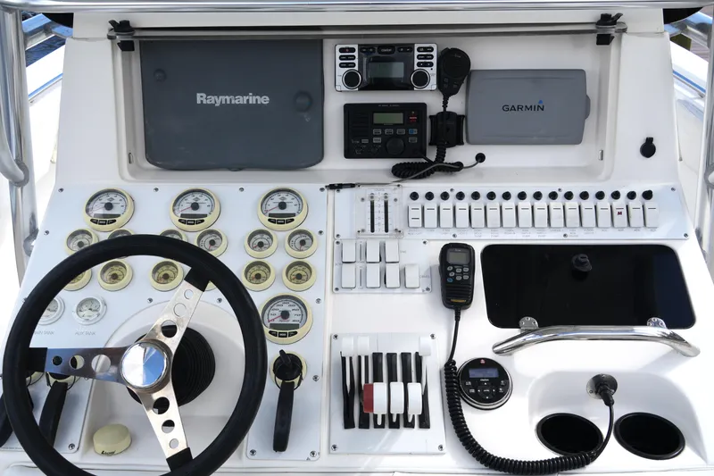 Slide: The Image of Control panel of a 2005 Fountain 34 Tournament Edition boat with gauges and navigation equipment. - 26