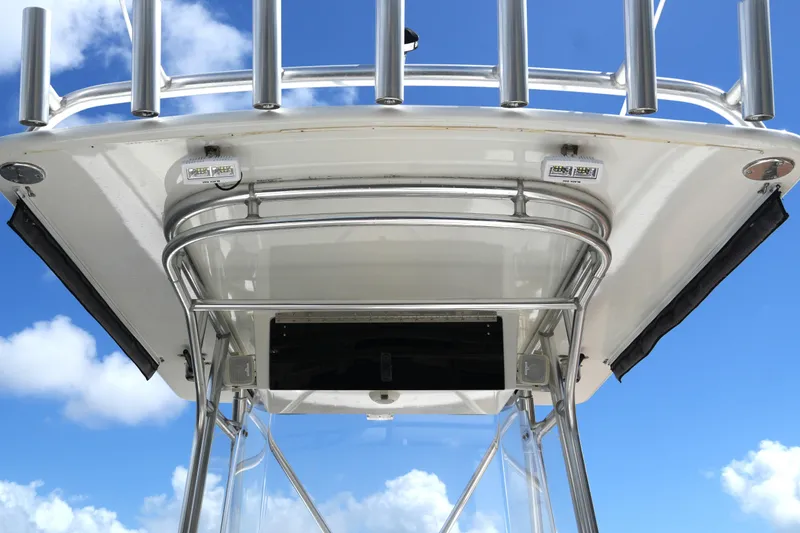 Slide: The Image of 2005 Fountain 34 Tournament Edition boat with stainless steel T-top against blue sky. - 28