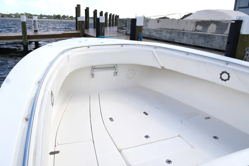 Slide: The Image of 2005 Fountain 34 Tournament Edition boat interior at dock, showcasing spacious white deck. - 31
