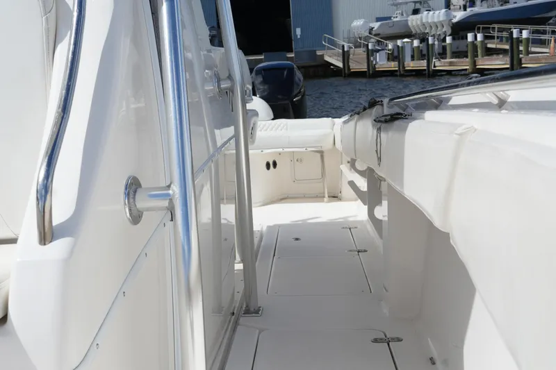 Slide: The Image of 2005 Fountain 34 Tournament Edition boat deck with stainless steel railings, docked at marina. - 34