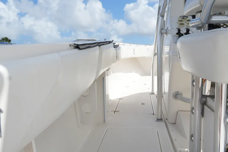 Slide: The Image of 2005 Fountain 34 Tournament Edition boat deck under a bright blue sky. - 37