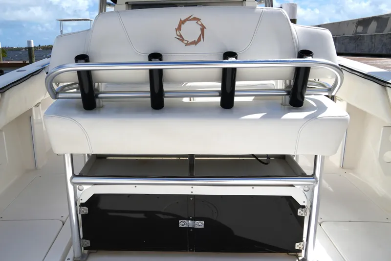 Slide: The Image of 2005 Fountain 34 Tournament Edition boat interior with white seating and rod holders. - 41