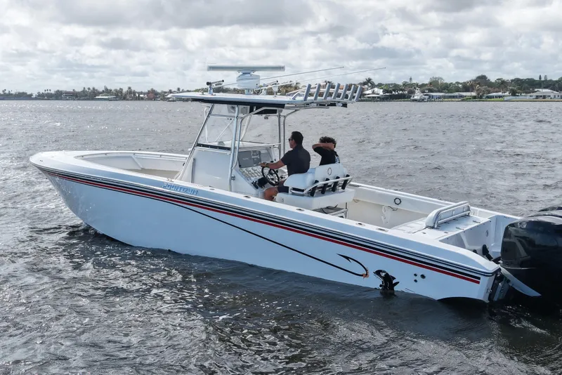 Slide: The Image of 2005 Fountain 34 Tournament Edition boat on water, two people onboard, overcast sky. - 8