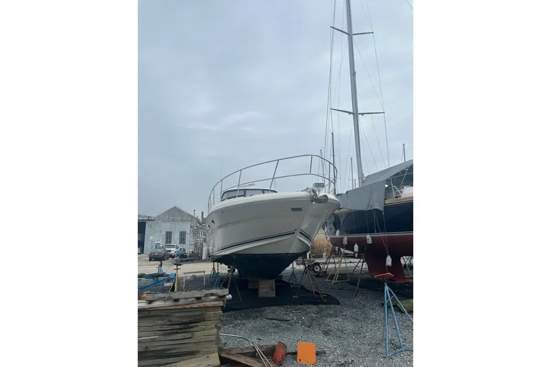 Slide: The Image of 2004 Sea Ray 420 Sundancer yacht bathroom with toilet, sink, and porthole window. - 20