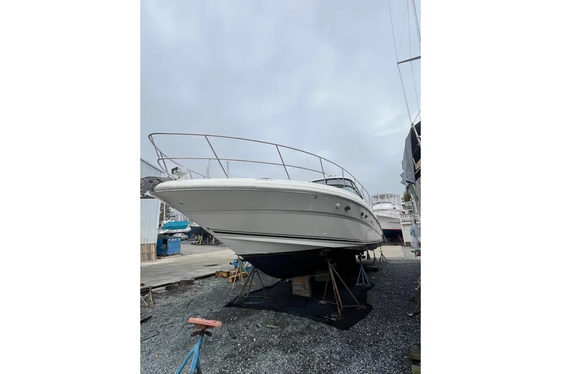 Slide: The Image of 2004 Sea Ray 420 Sundancer yacht on dry dock, ready for maintenance. - 9