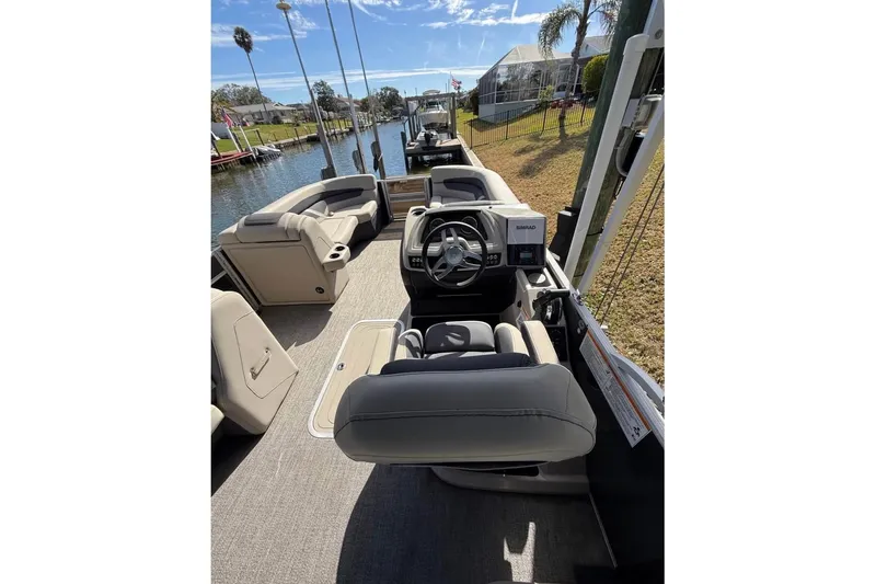 Slide: The Image of 2023 Barletta C22CC pontoon boat interior with helm and seating area. - 5