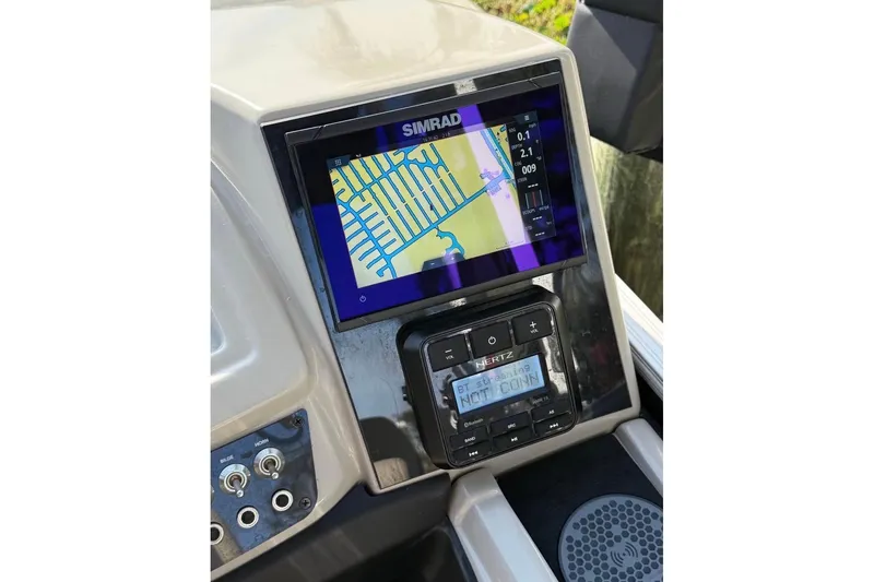 Slide: The Image of Dashboard of 2023 Barletta C22CC with Simrad navigation system and Hertz audio controls. - 7