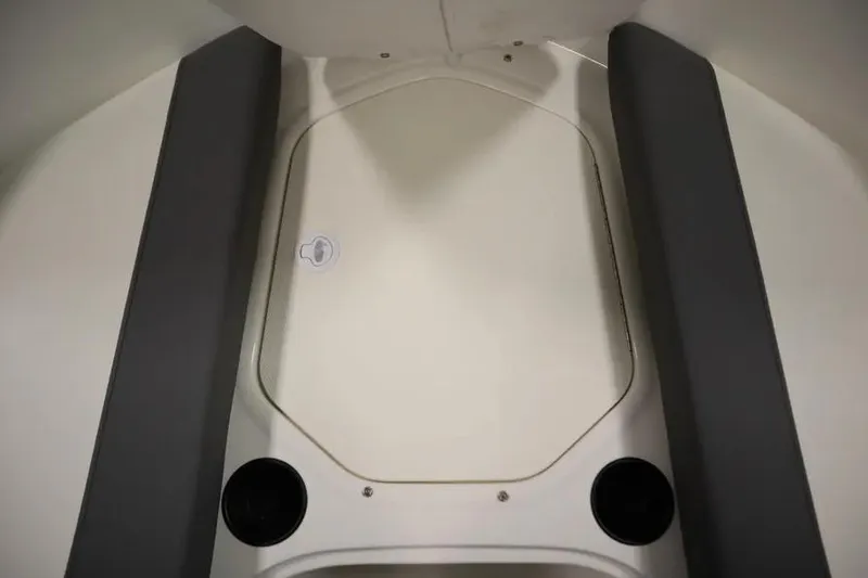 Slide: The Image of Interior view of 2025 Bayliner Element E18 boat, featuring seating and storage area. - 18