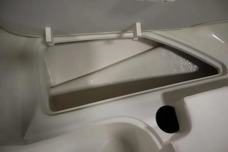 Slide: The Image of 2025 Bayliner Element E18 storage compartment, open lid, showcasing interior space. - 20