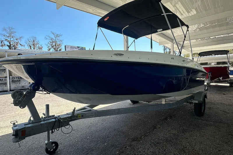 Slide: The Image of 2025 Bayliner Element E18 boat on trailer under a canopy. - 3