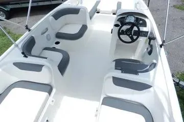 Slide: The Image of 2025 Bayliner Element E18 boat interior with modern seating and steering console. - 4