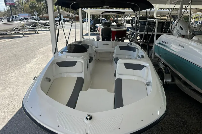 Slide: The Image of 2025 Bayliner Element E18 boat with spacious seating, displayed in a showroom. - 5