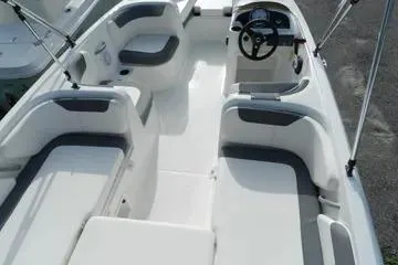 Slide: The Image of 2025 Bayliner Element E18 boat interior with seating and steering wheel. - 7