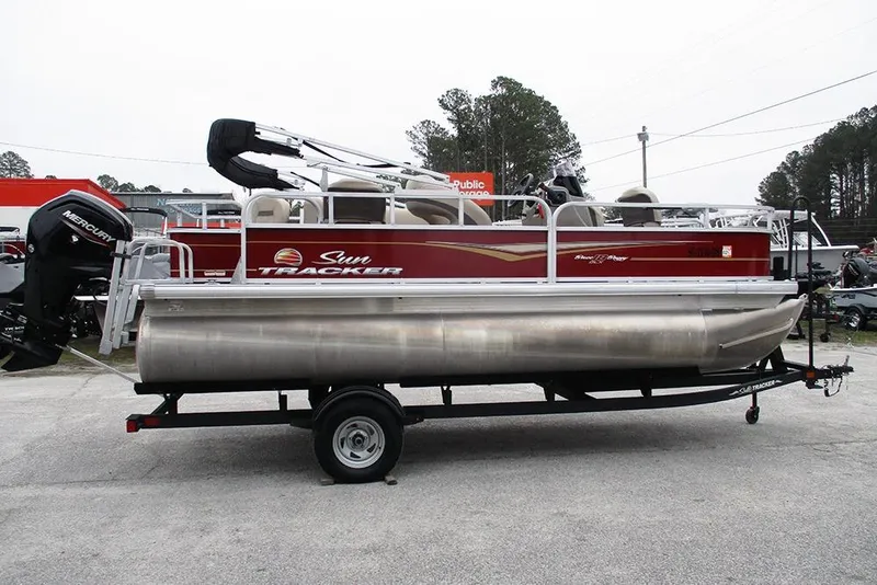 The Image of 2022 Sun Tracker Bass Buggy 18 DLX pontoon boat on trailer, side view. - 1