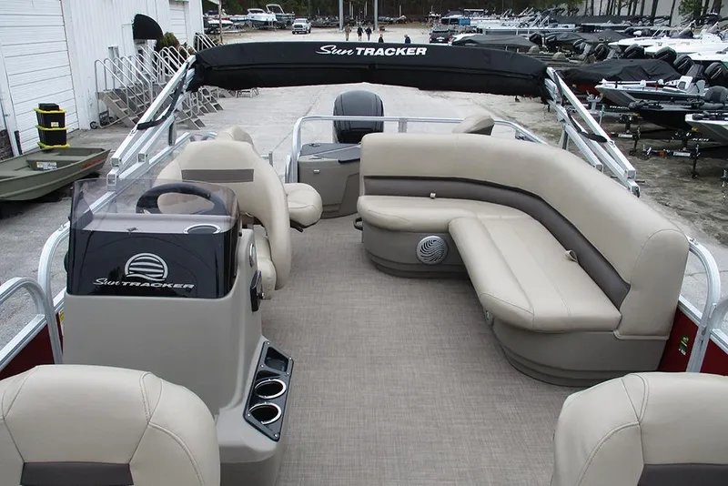 Slide: The Image of 2022 Sun Tracker Bass Buggy 18 DLX pontoon boat interior with beige seating. - 10