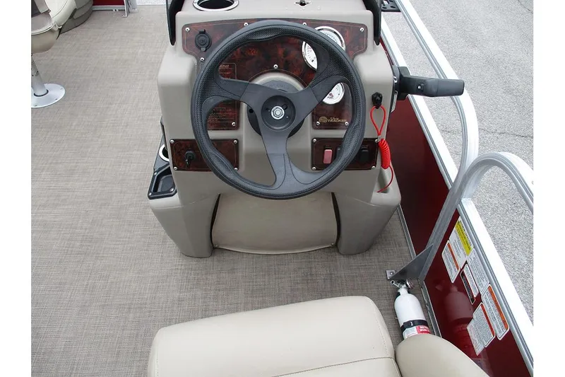 Slide: The Image of 2022 Sun Tracker Bass Buggy 18 DLX steering console with gauges and controls. - 24