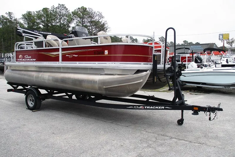 Slide: The Image of 2022 Sun Tracker Bass Buggy 18 DLX pontoon boat on trailer in outdoor setting. - 3