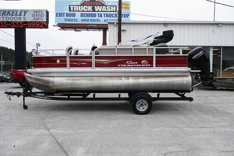 Slide: The Image of 2022 Sun Tracker Bass Buggy 18 DLX pontoon boat on trailer, parked outside dealership. - 6