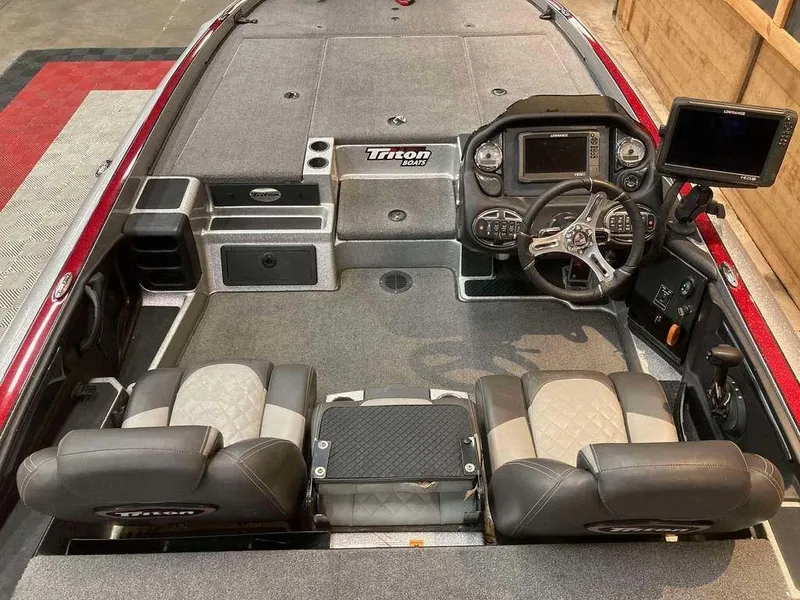 Slide: The Image of 2017 Triton 21 TrX boat interior with dual seats and advanced dashboard controls. - 6