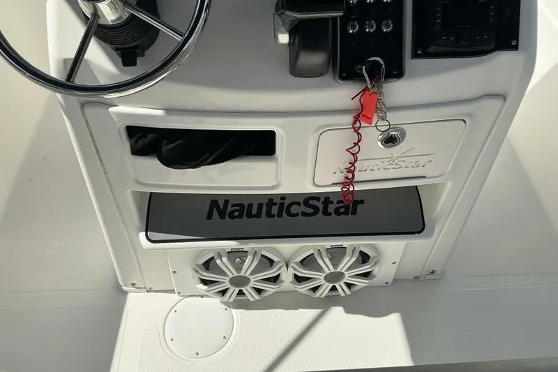 Slide: The Image of 2015 NauticStar 231 Hybrid boat console with steering wheel and controls. - 10