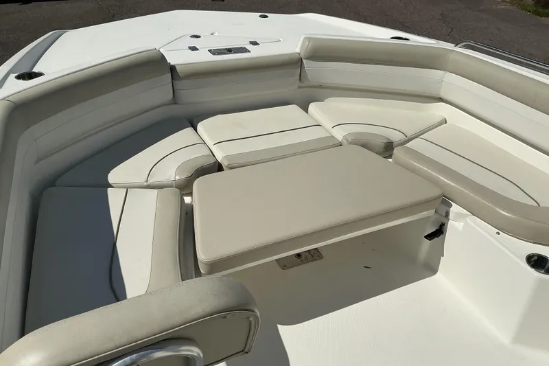 Slide: The Image of 2015 NauticStar 231 Hybrid boat interior with cushioned seating area. - 14