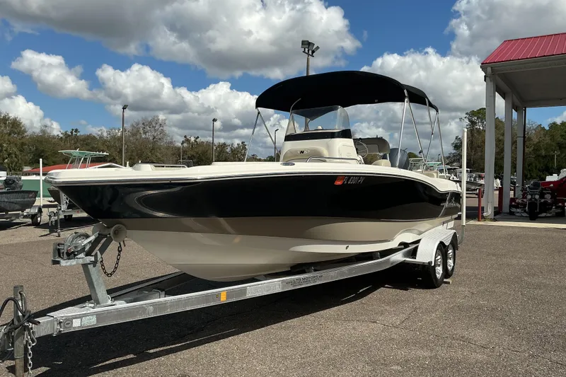 Slide: The Image of 2015 NauticStar 231 Hybrid boat on trailer under cloudy sky. - 3