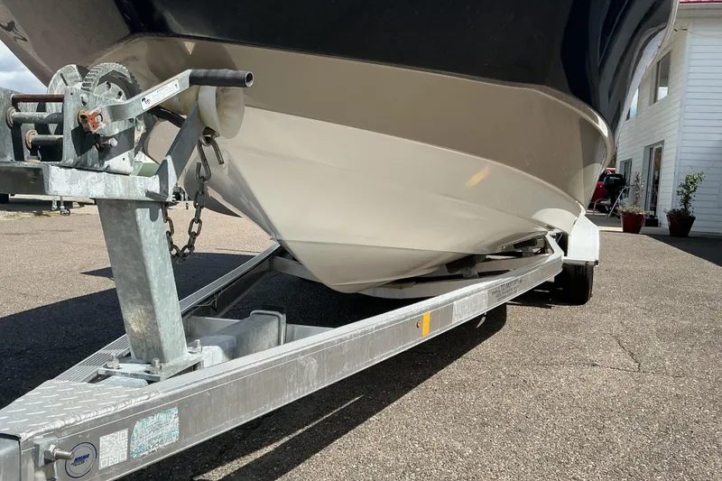 Slide: The Image of 2015 NauticStar 231 Hybrid boat on trailer, close-up view. - 6