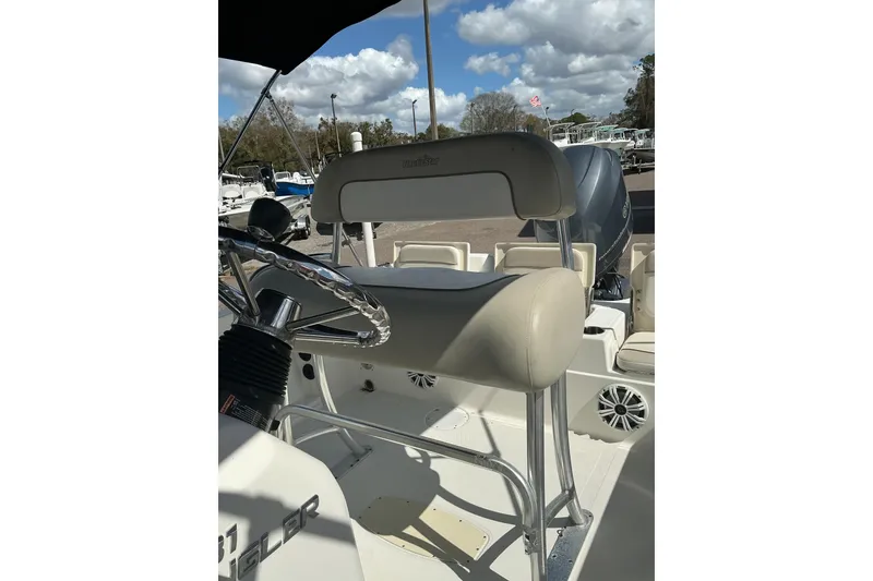 Slide: The Image of 2015 NauticStar 231 Hybrid boat interior with steering wheel and seating. - 8