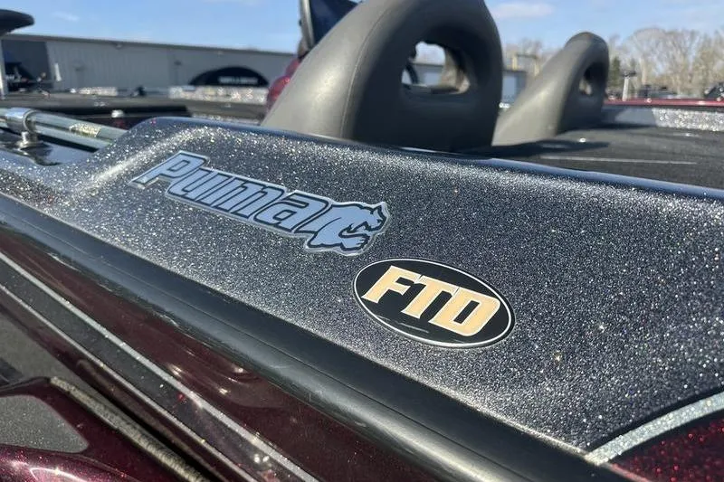 Slide: The Image of 2014 Bass Cat Puma FTD boat with metallic finish and logo detail. - 3