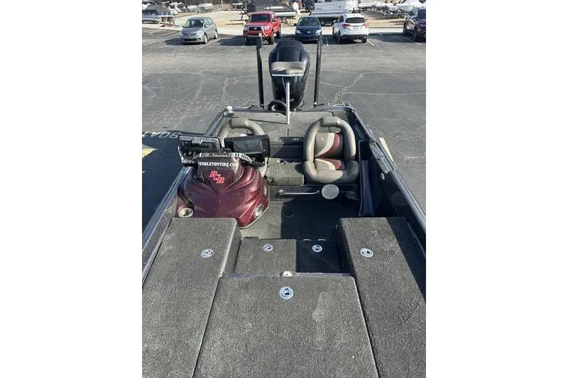 Slide: The Image of 2014 Bass Cat Puma FTD boat interior with seats and equipment in a parking lot. - 4