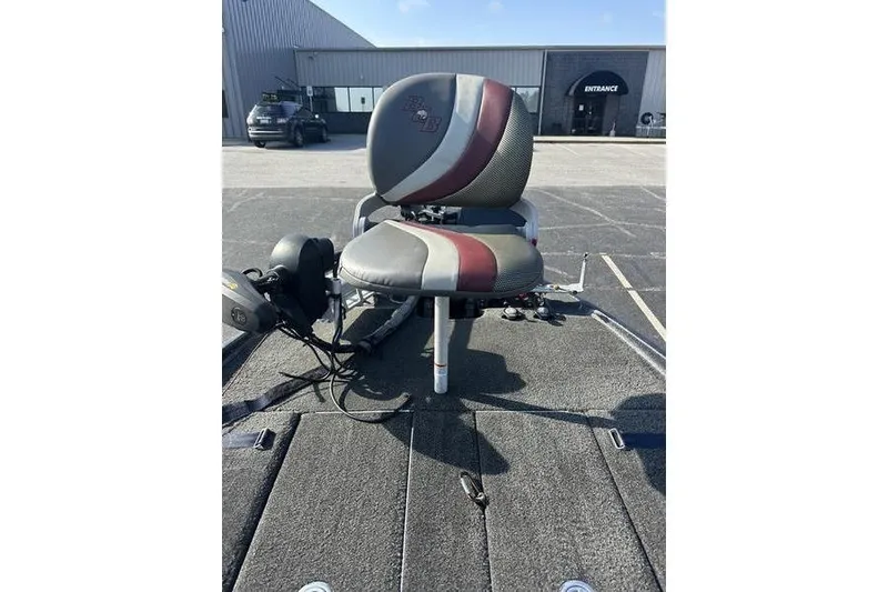 Slide: The Image of 2014 Bass Cat Puma FTD boat seat with red and gray design in a parking lot. - 5