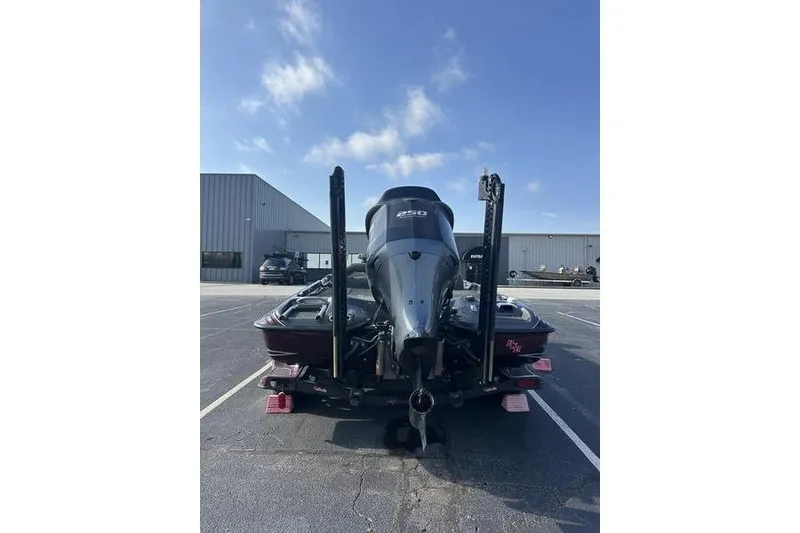Slide: The Image of 2014 Bass Cat Puma FTD boat, rear view in parking lot under blue sky. - 6