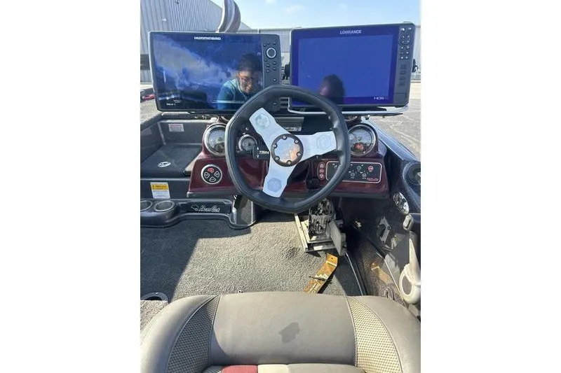 Slide: The Image of 2014 Bass Cat Puma FTD boat dashboard with dual fish finders and steering wheel. - 8